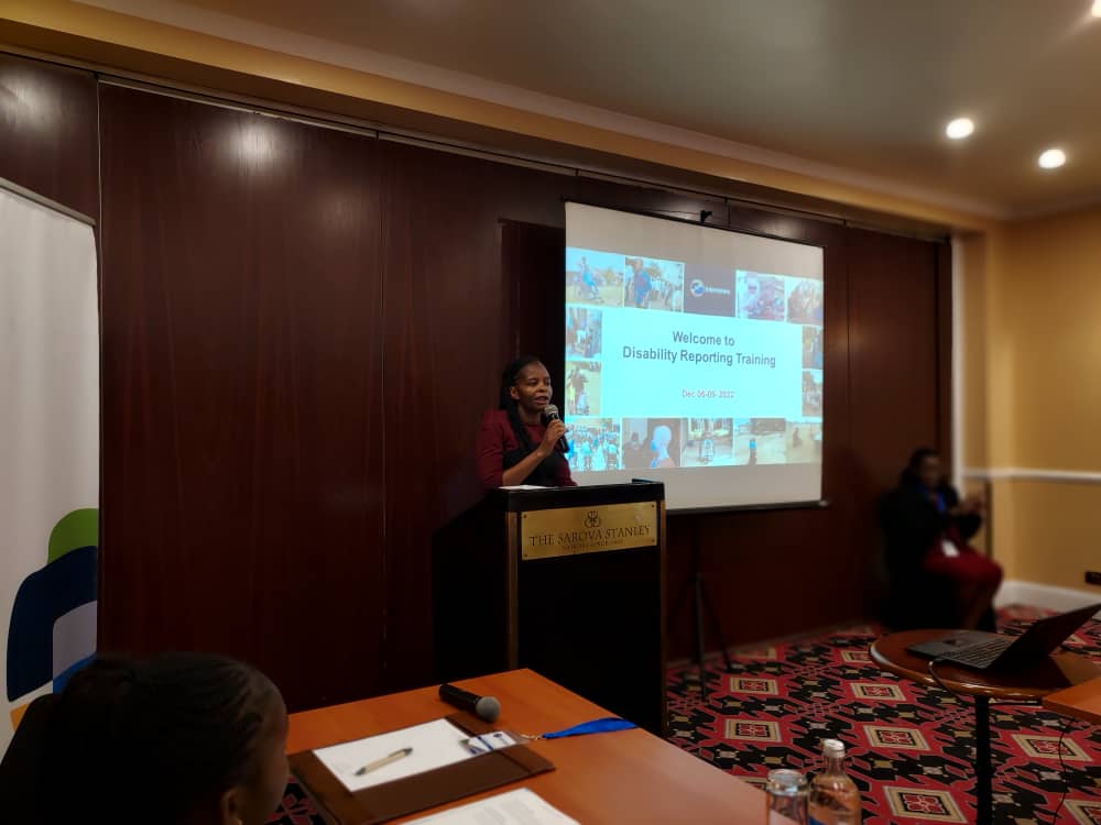 Internews workshop at Sarova Stanley. Jackline Lidubwi is standing behind a lectern holding a microphone