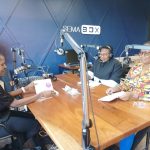 Liz Orembo, Anita Epalle and Mylline Anunda in a studio recording a podcast.