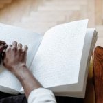 A Person Touching a Braille Book