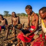 African warrior from Samburu tribe using laptop on savanna, central Kenya, Africa. Samburu tribe is one of the biggest tribes of north-central Kenya, and they are related to the Maasai.