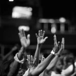 People in a forum raising their hands