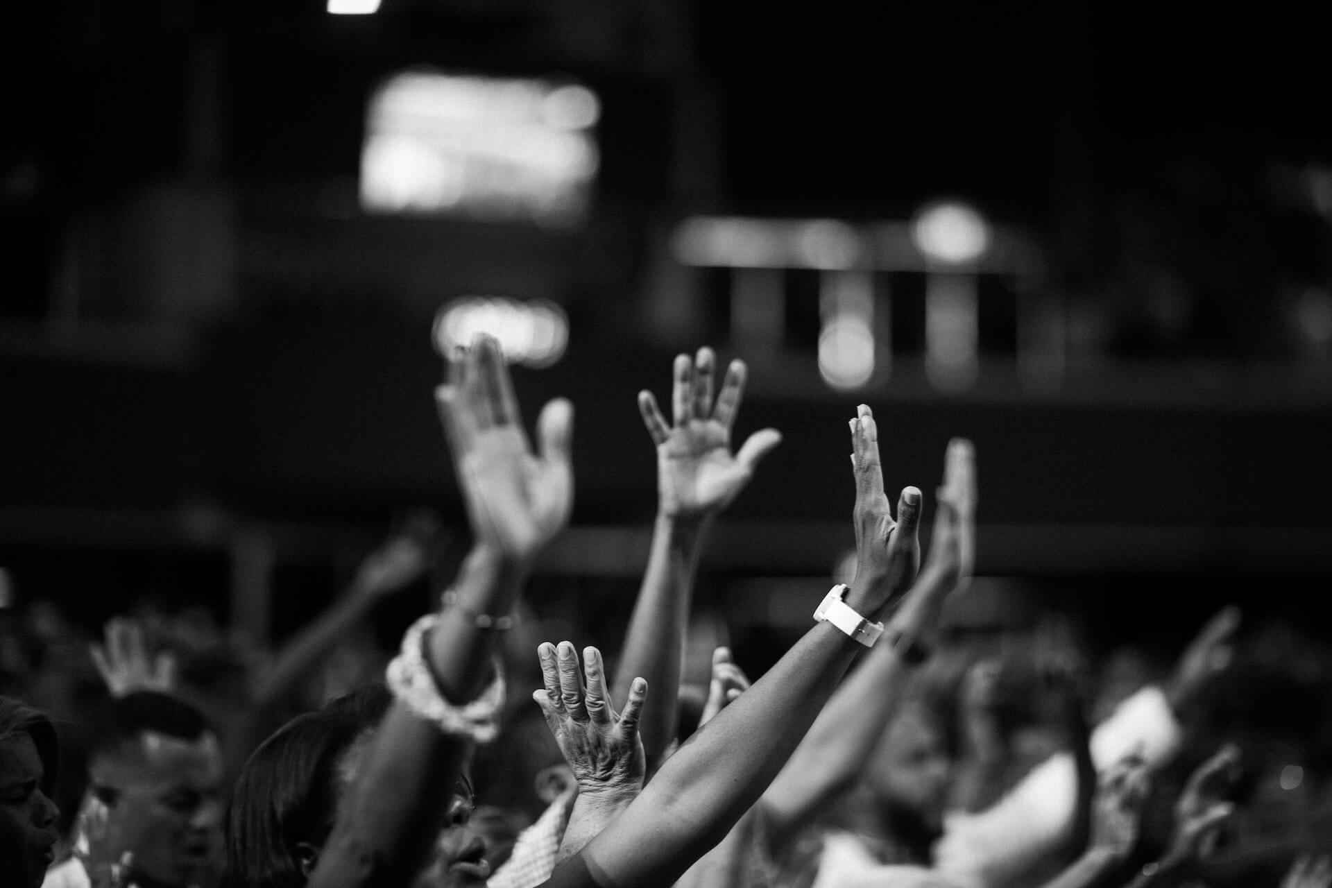 People in a forum raising their hands