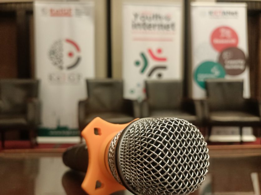 A microphone on a podium against a blurred background of KeIGF2023 banners