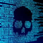 Computer code seen on a screen with a skull representing a computer virus attack. Photo: Shutterstock Images