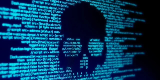 Computer code seen on a screen with a skull representing a computer virus attack. Photo: Shutterstock Images