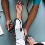 Doctor checking a patients' pulse