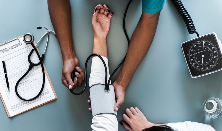 Doctor checking a patients' pulse