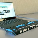 A laptop on a table attached to a braille keyboard