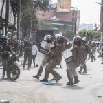 Police officers halt a motor bike rider during the anti finance 2024 finance bill in Kenya. Photo Frank Omondi